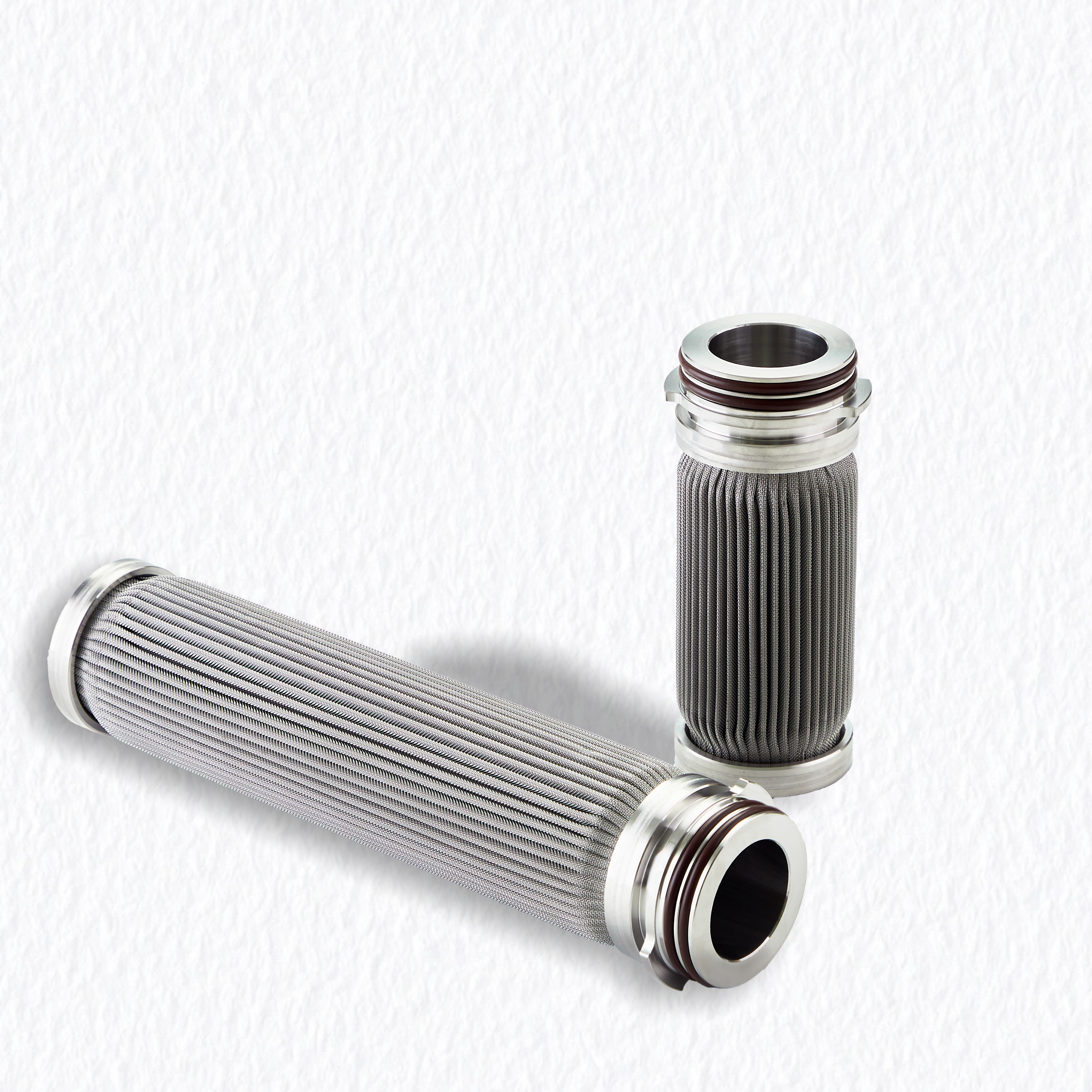Vista lateral de cartuchos filtrantes cil&iacute;ndricos de a&ccedil;o inoxid&aacute;vel sinterizado projetados para aplica&ccedil;&otilde;es de fus&atilde;o de pol&iacute;meros e filtra&ccedil;&atilde;o de resina.